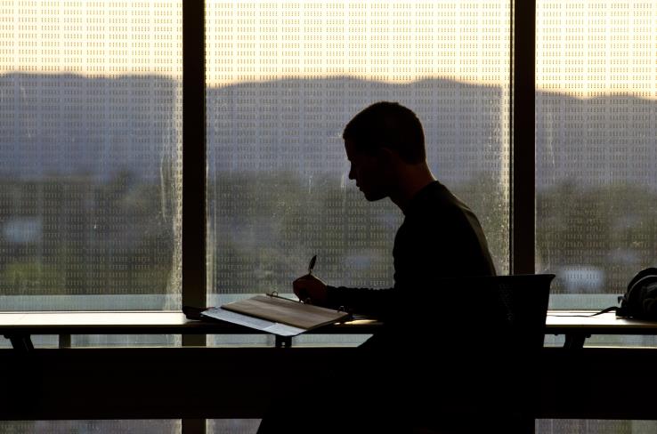 A student sitting at a desk working on their classwork.